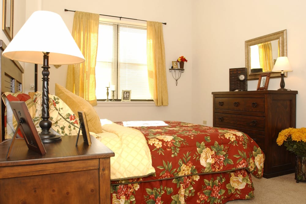 bedroom with bed, lamp and nightstand