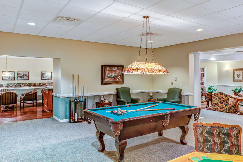 Brightly lit game room complete with pool tables at Grand Victorian of Rockford in Rockford, Illinois