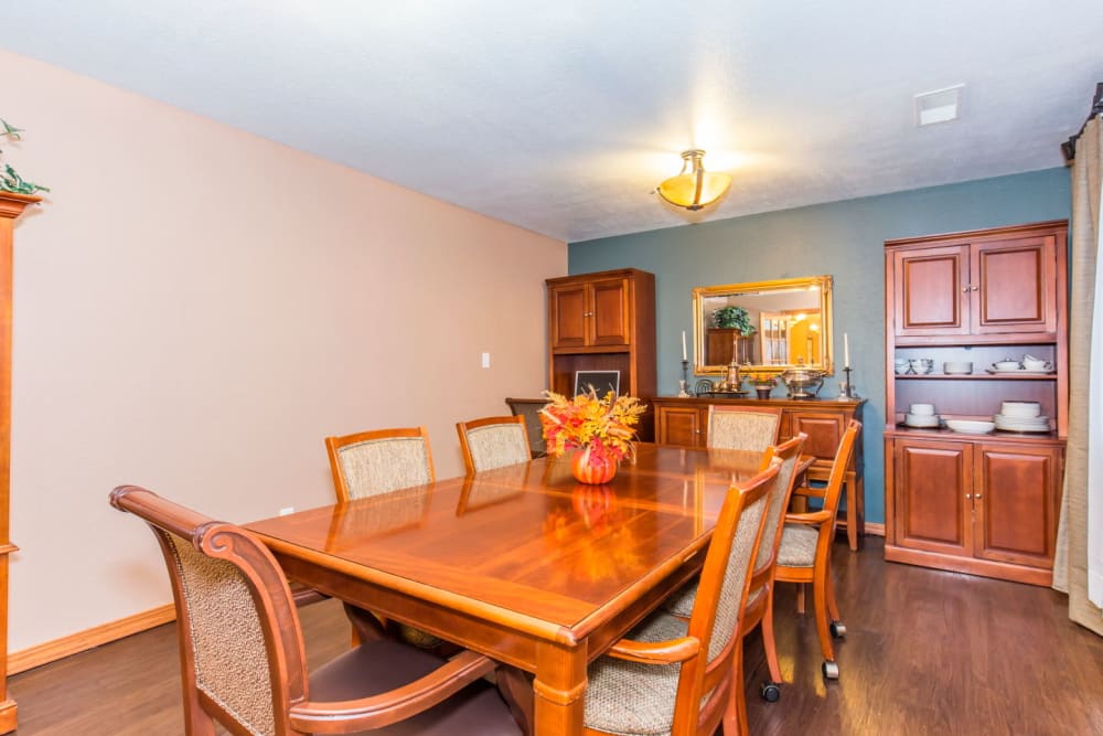 Dining room with wood table and bright lighting at Brookstone Estates of Rantoul in Rantoul, Illinois