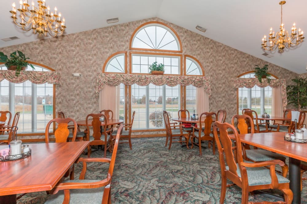 Elegant dining room with beautiful window and chandelier at Brookstone Estates of Paris in Paris, Illinois