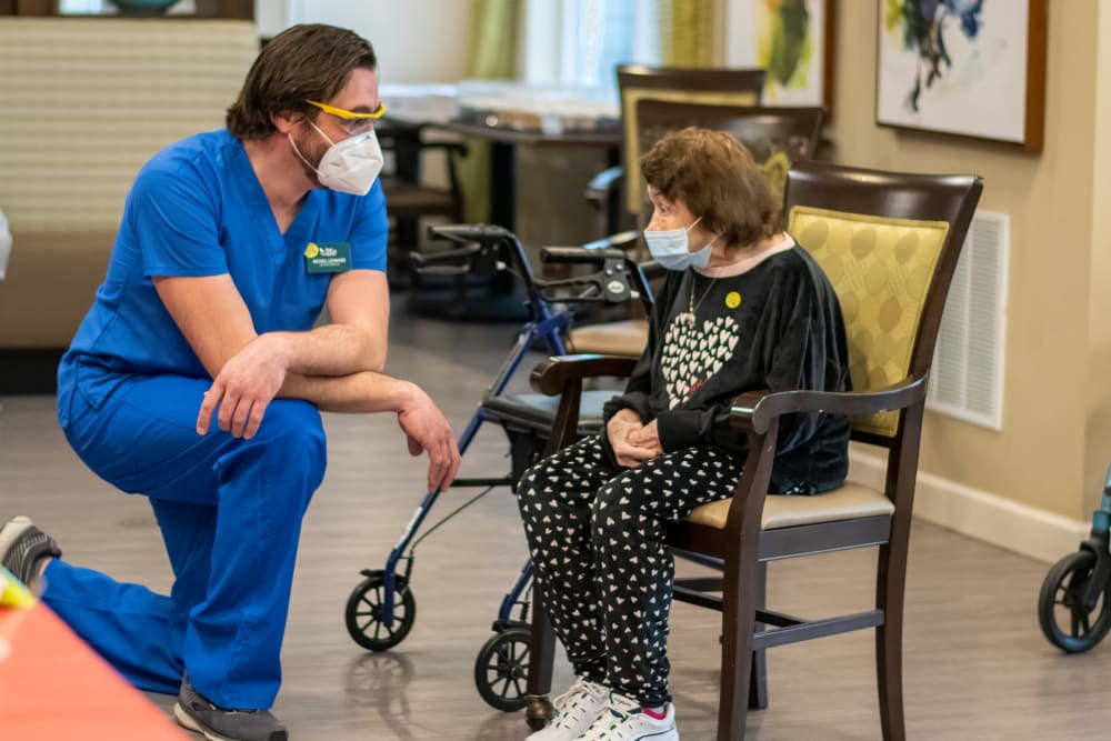 senior resident speaking with a nurse