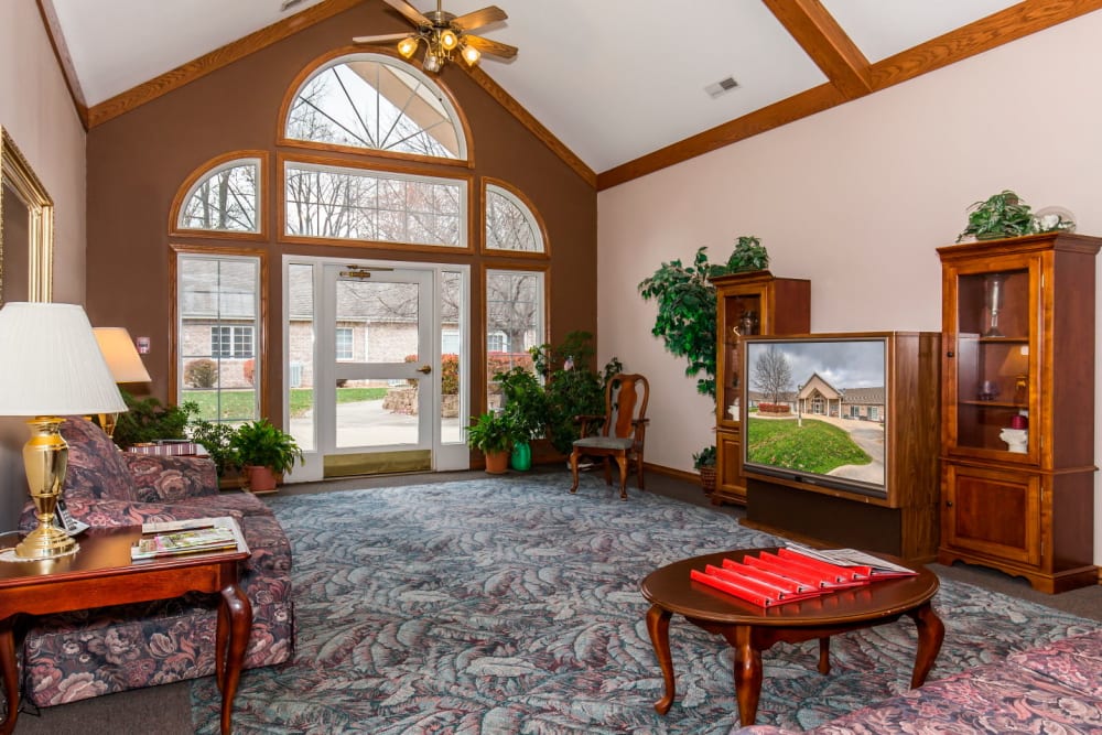 TV room complete with large window and wood accents at Brookstone Estates of Paris in Paris, Illinois