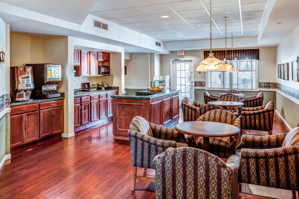 Lounge seating with kitchen island and beverage dispensers at Grand Victorian of Rockford in Rockford, Illinois