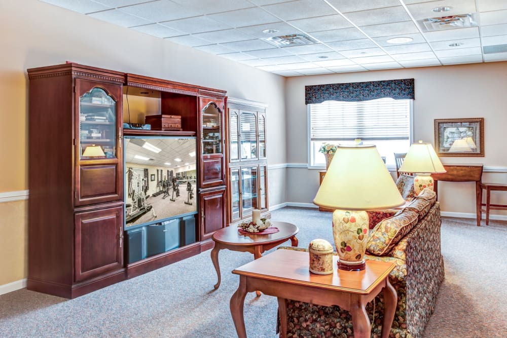 Television lounge area  with wood accents at Grand Victorian of Rockford in Rockford, Illinois